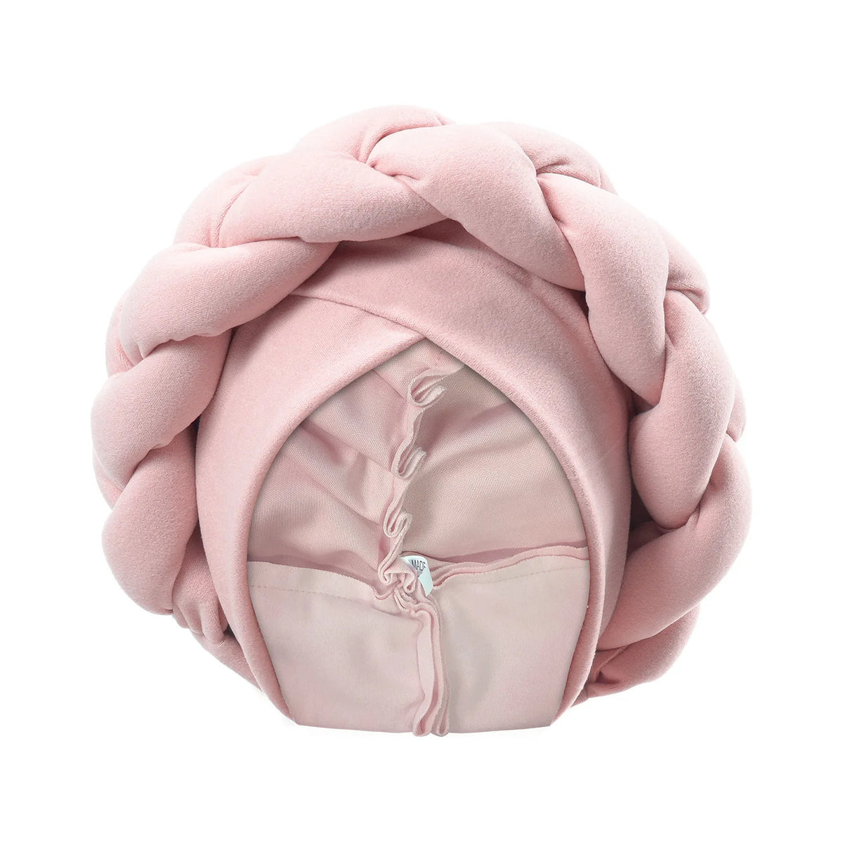 A pink braided turban cap made of soft fabric for African party headwear.