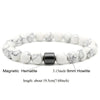 A bracelet made of white and black marbled hematite beads with a black howlite spacer.