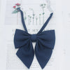 A dark navy blue solid cotton bow tie shown against a white background.