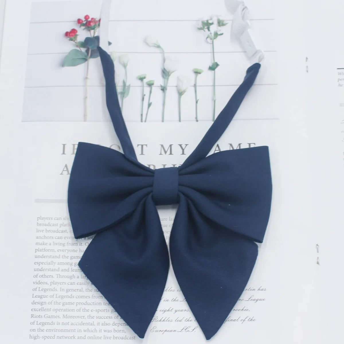 A dark navy blue solid cotton bow tie shown against a white background.