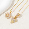 Gold-toned necklace set featuring crystal pendants shaped like the letters A and V.