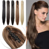 A woman shows off long brown hair extensions styled in a ponytail and straight, loose hair.