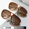Brown tortoiseshell aviator style sunglasses resting on a white surface.