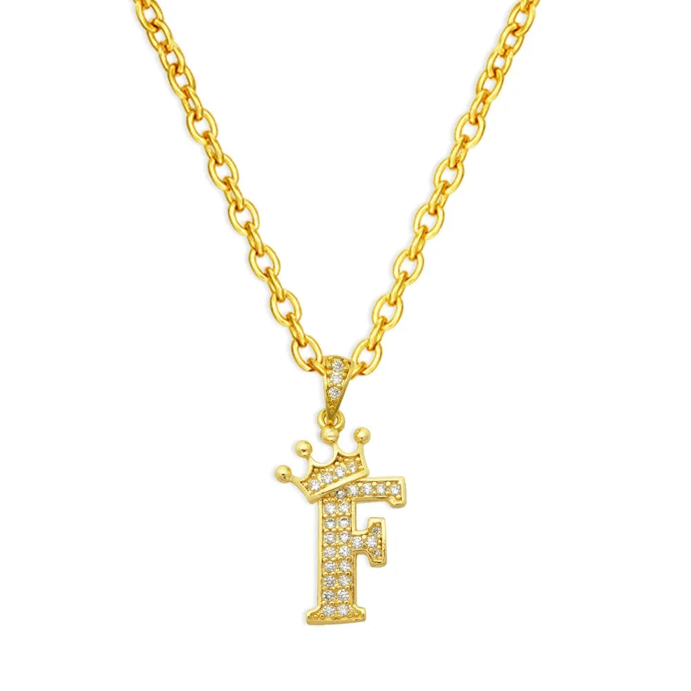 Gold chain necklace with a large initial F pendant featuring a crown design
