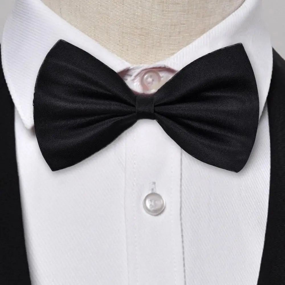 Classic black knit bow tie worn on a white dress shirt.