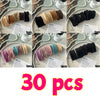 A collection of black and tan elastic hair bands for ponytails shown in various colors and sizes.