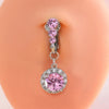 A silver and pink gemstone belly button ring featuring a cluster of small pink stones and a large pink round stone.