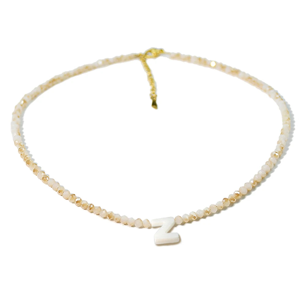 A delicate necklace featuring a Z initial made of mother of pearl with small crystal accents.