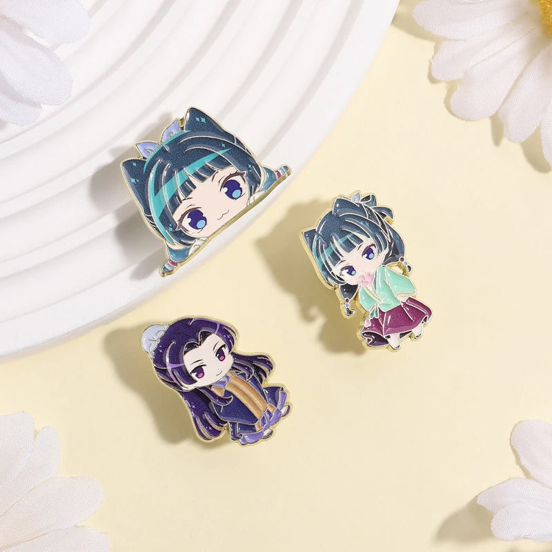 A set of cute anime character lapel pins featuring two female characters with dark hair and blue eyes on a light background.