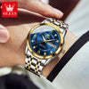 A close-up of a men's stainless steel watch with a blue dial and gold accents worn on a wrist.