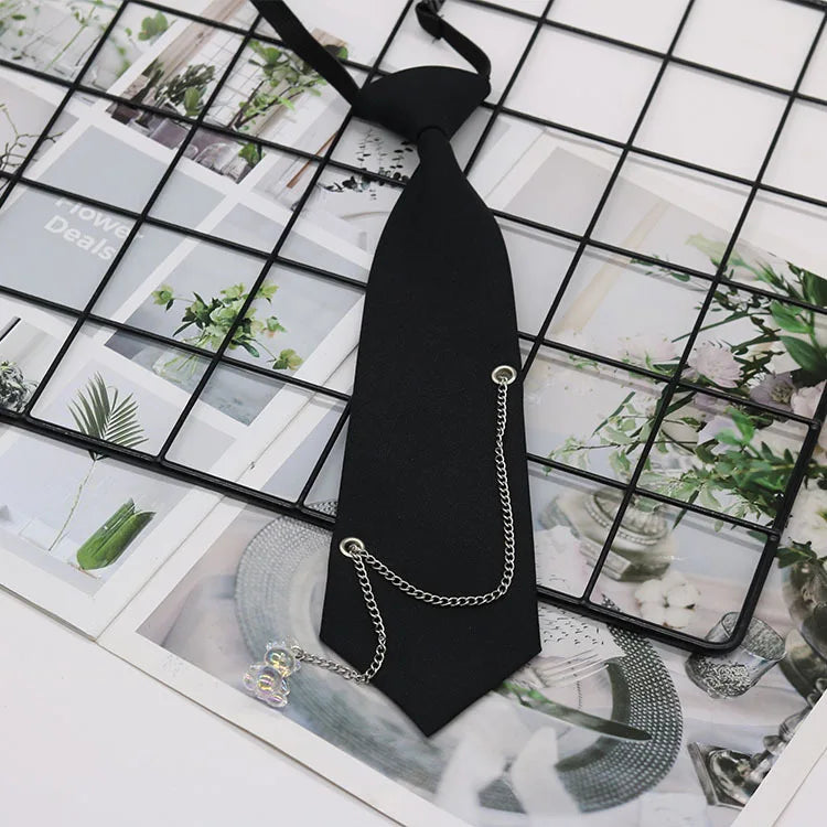 A black classic chain necktie accessory is displayed against a grid background with floral and natural imagery.