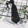 A black classic chain necktie is displayed against a grid background with floral imagery.