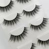 A set of handmade mink strip eyelashes displayed on a white plastic tray.