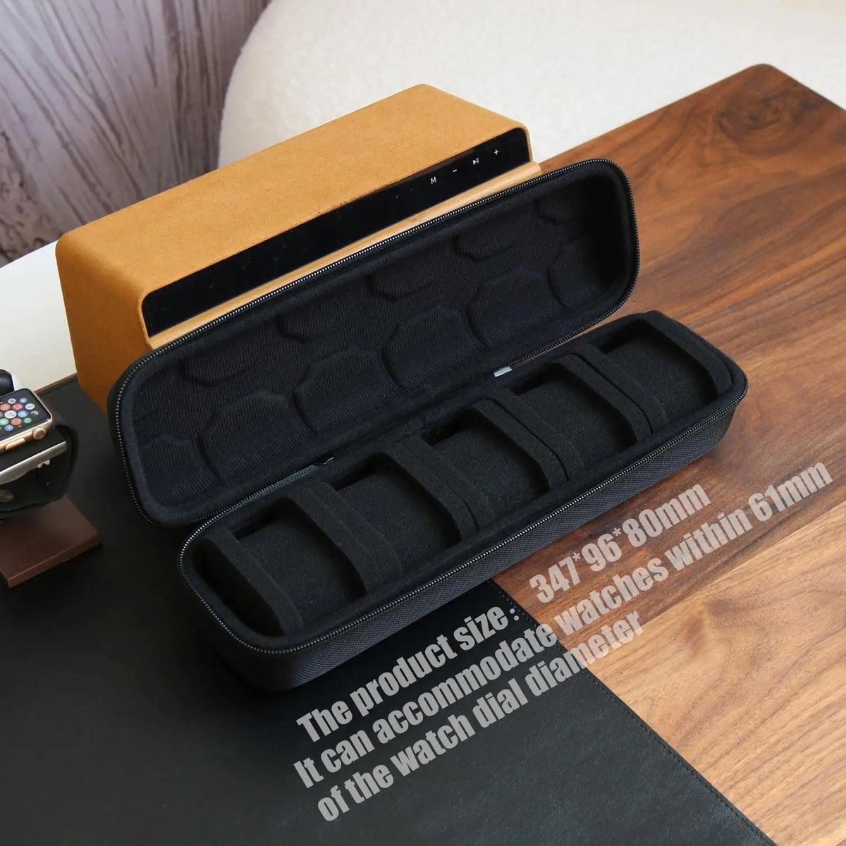A black leather watch travel case organizer is shown open on a wooden surface.