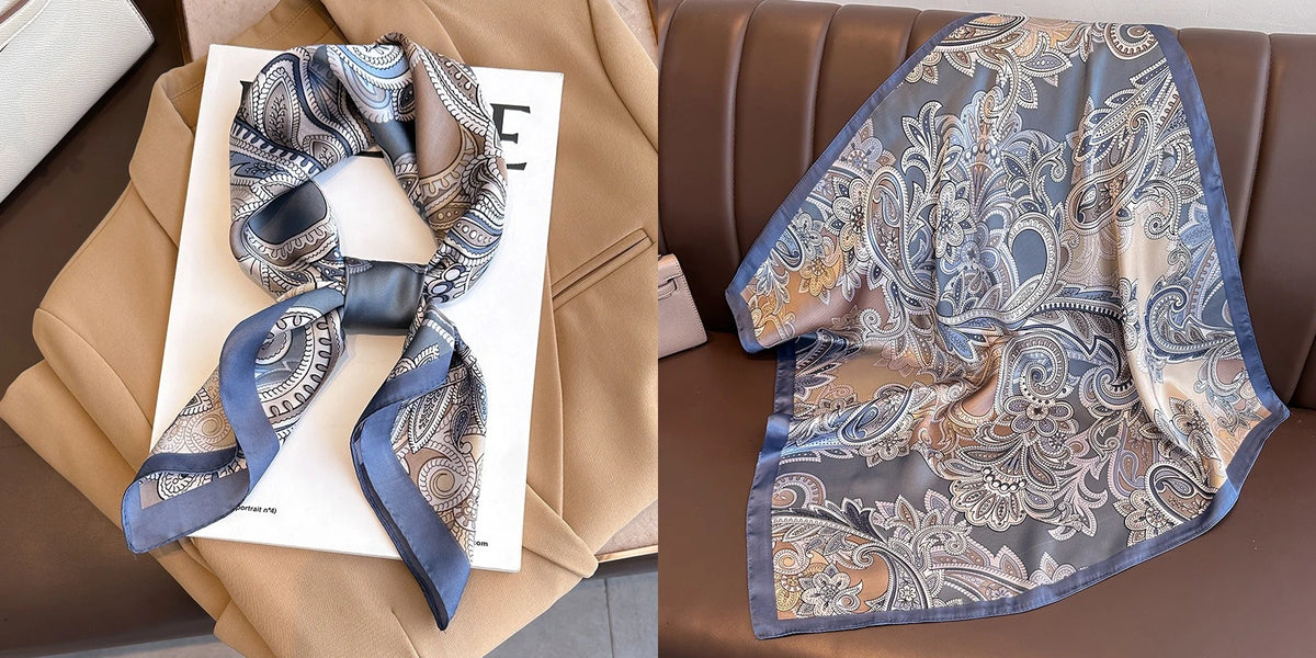 A silky scarf with a floral print in blue and gold tones is displayed next to a tan blazer.
