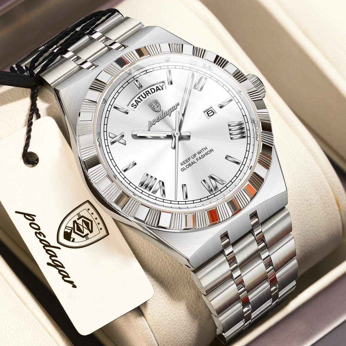 A silver men's luminous quartz wristwatch with a metal bracelet and leather tag is displayed in a box.
