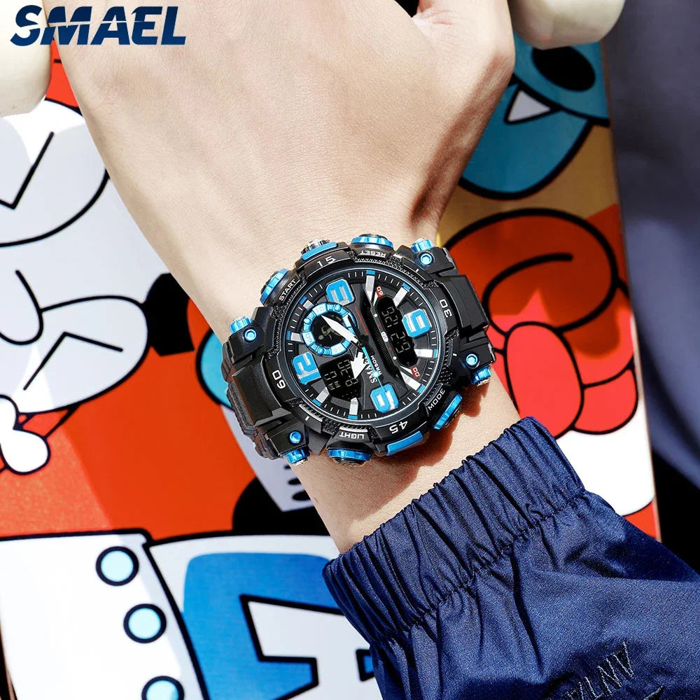 A close-up of a black digital wristwatch with blue accents on a person's wrist, worn against a colorful background.