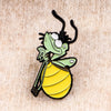 A cute firefly enamel pin featuring a frog-like character with green skin and yellow stripes.