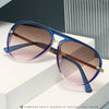 A pair of purple-tinted aviator style sunglasses with gold accents displayed on a white surface.