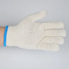 A close-up of a cream-colored cotton thread work glove with blue trim, shown against a white background.