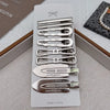 A set of vintage silver Y2K metal hair clips arranged vertically on a white card.