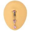 Silver belly button rings with a pink gemstone and a delicate floral charm