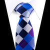 A blue and purple patterned silk necktie tied in a diamond knot, worn under a white dress shirt.