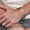 A close-up of a man's wrist wearing a rose gold copper magnetic bracelet against a white shirt and dark pants.