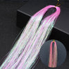 Long pink and white glitter hair extensions strands displayed against a dark background.