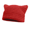 A knitted red crocheted beanie hat with cat ear style.