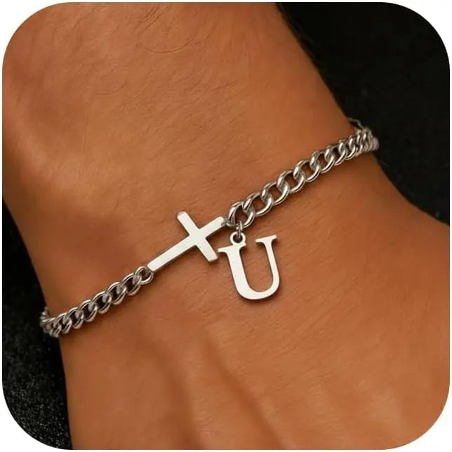 A close-up of a personalized stainless steel cross Cuban chain bracelet worn on a wrist.