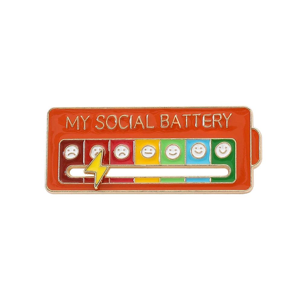 An orange brooch pin featuring a battery graphic with various facial expressions.