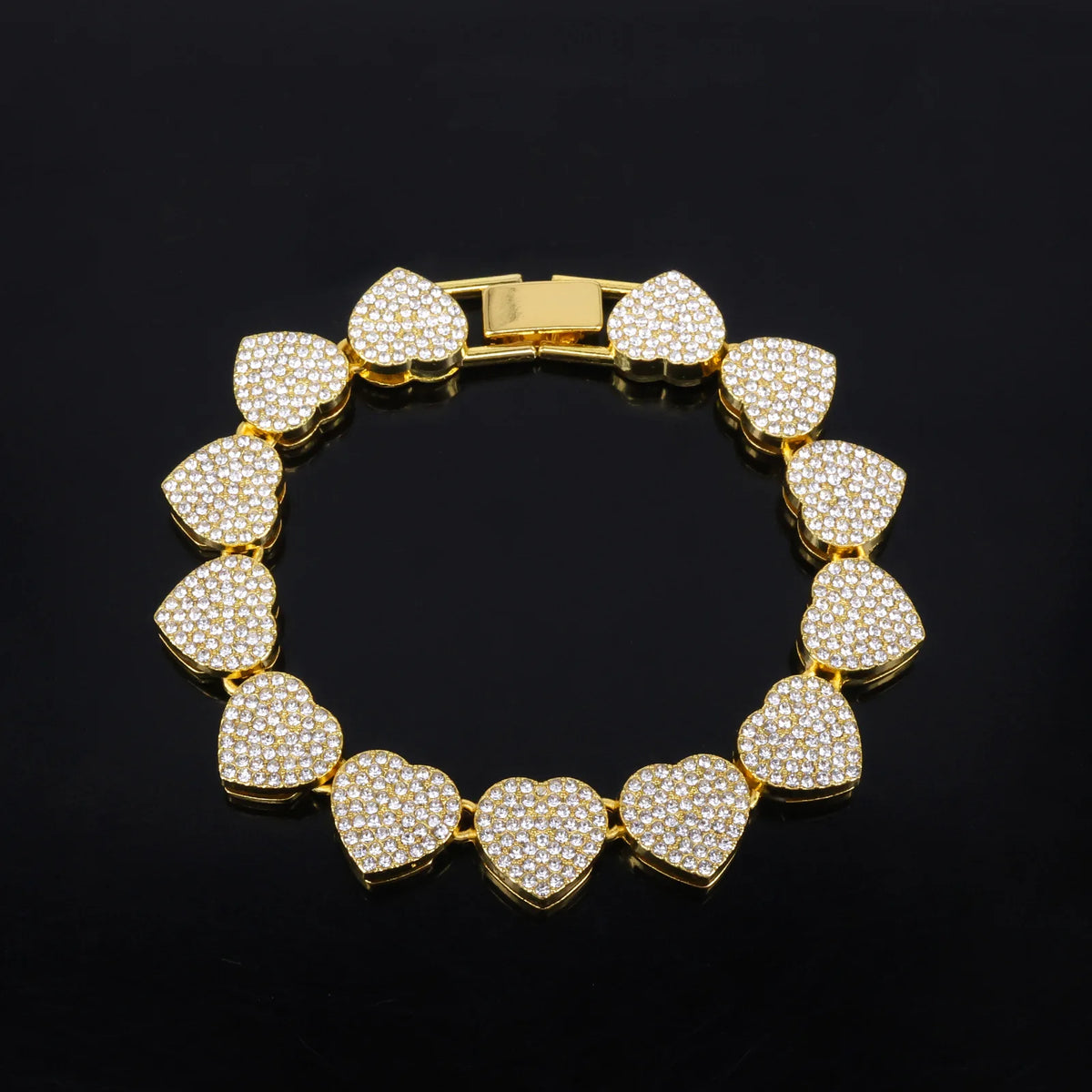 A gold-toned necklace and bracelet set featuring heart-shaped charms encrusted with sparkling rhinestones.