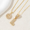 Gold-toned necklace set featuring CZ crystal pendants shaped like the letter D and E.