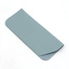A slim, light blue PU leather glasses case folded and shown from the side.