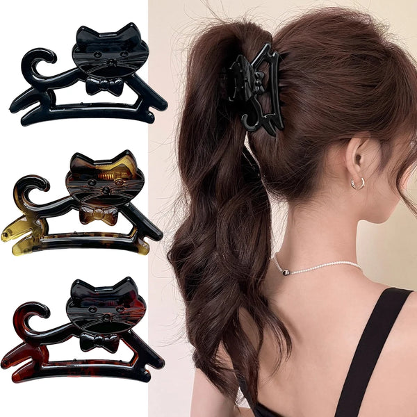 A set of three black and amber cartoon cat-shaped hair clips for styling