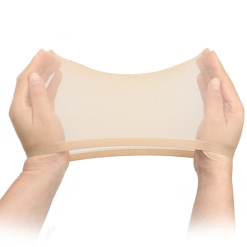 Hands holding a sheer beige wig cap or hair netting fabric.