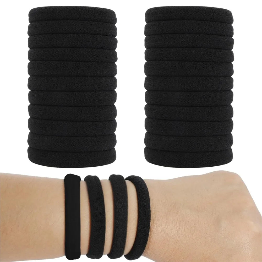 A set of black seamless hair ties stacked and displayed on a wrist.