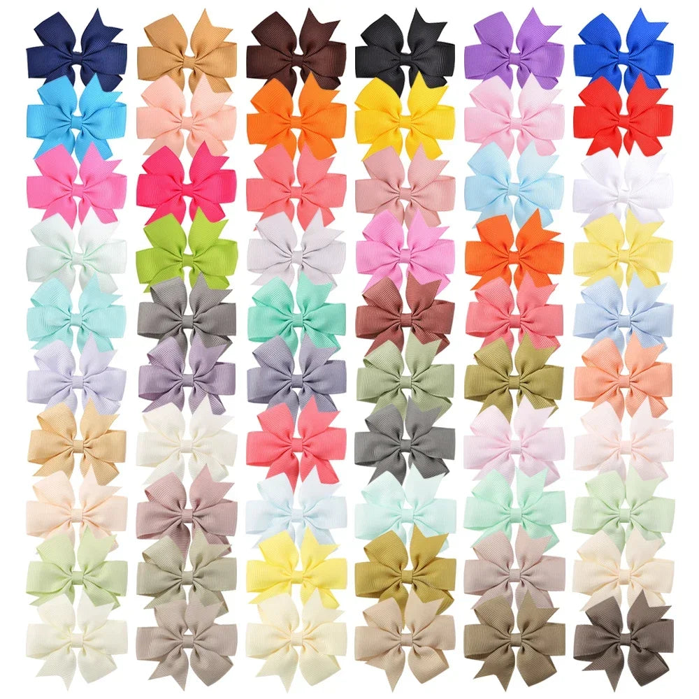 Assorted grosgrain ribbon hair bow clips in various pastel and earth tones for girls