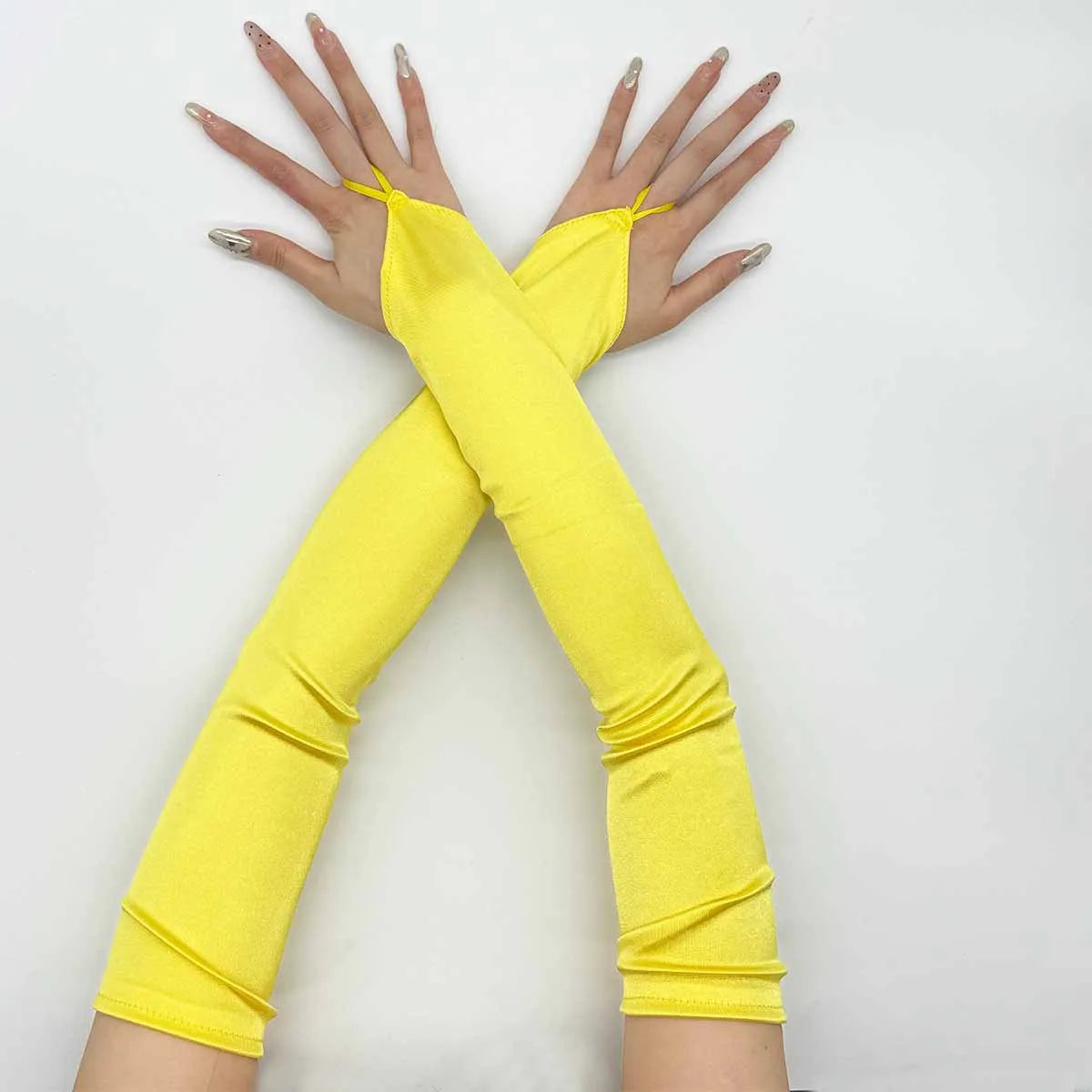 A pair of bright yellow satin fingerless gloves crossed in an 'X' shape.