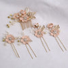 A set of five floral pearl bridal hair accessories featuring light pink flowers and gold accents.