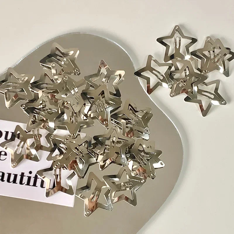 Silver Y2K sweet star barrettes hair clips scattered on a light surface.