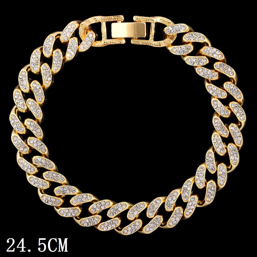A gold crystal Cuban link anklet bracelet shown against a black background.