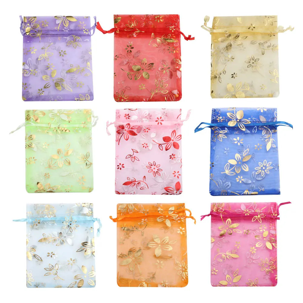 A collection of nine satin drawstring jewelry pouches in various colors and floral patterns.