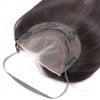A dark brown lace front hair topper is shown placed on a head, with a strap visible below.