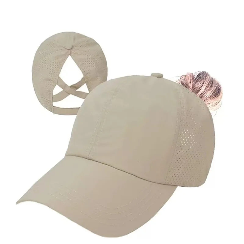 A beige breathable mesh criss-cross baseball cap with a pink detail on the side.
