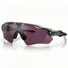 Purple polarized cycling sunglasses with a translucent frame resting on a reflective surface.