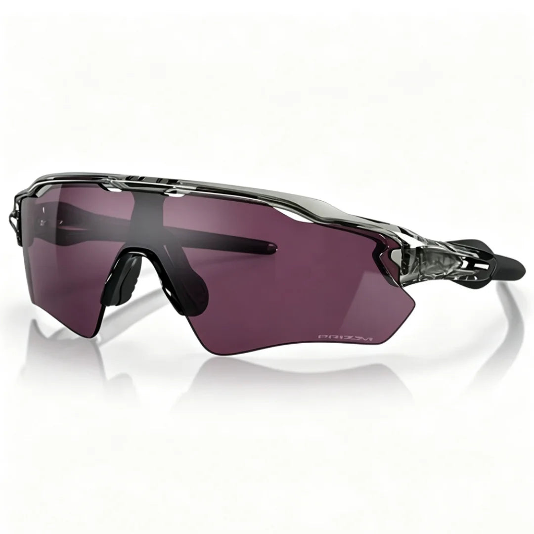 Purple polarized cycling sunglasses with a translucent frame resting on a reflective surface.