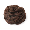 A dark brown hair piece styled in a large, messy bun for curly updos.