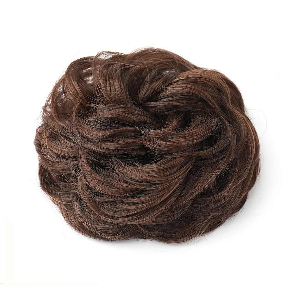 A dark brown hair piece styled in a large, messy bun for curly updos.